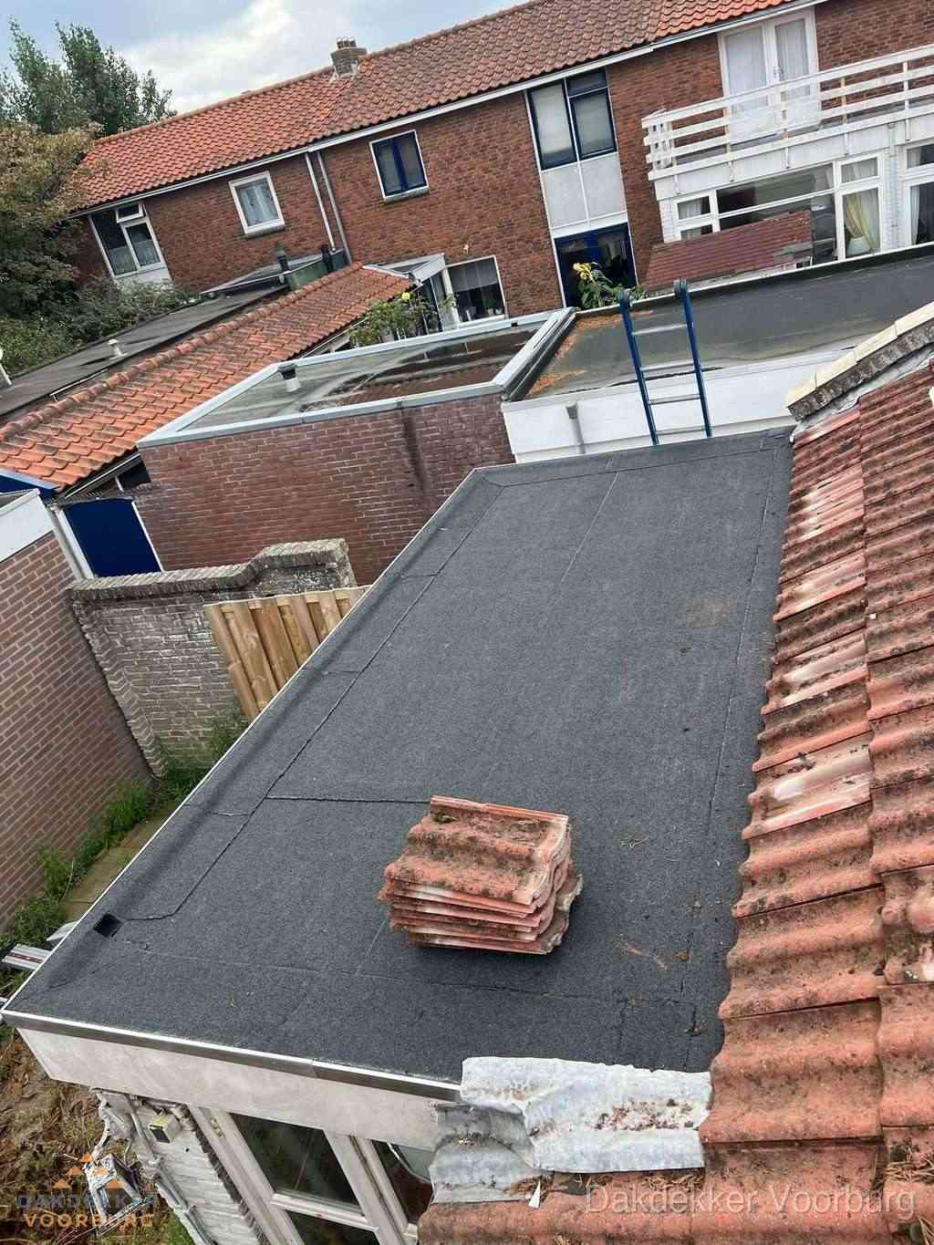 Aanbouw plat dak met reservepannen voor dakpannen vervangen in Voorburg
